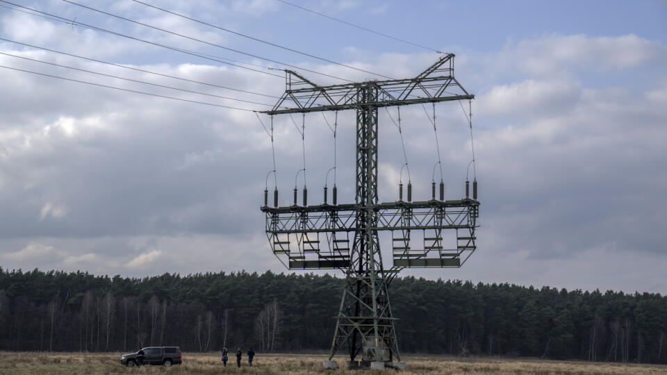 Policajti pracujú vedľa poškodeného stožiara v blízkosti továrne Tesla Gigafactory na elektromobily v Gruenheide pri Berlíne v Nemecku.