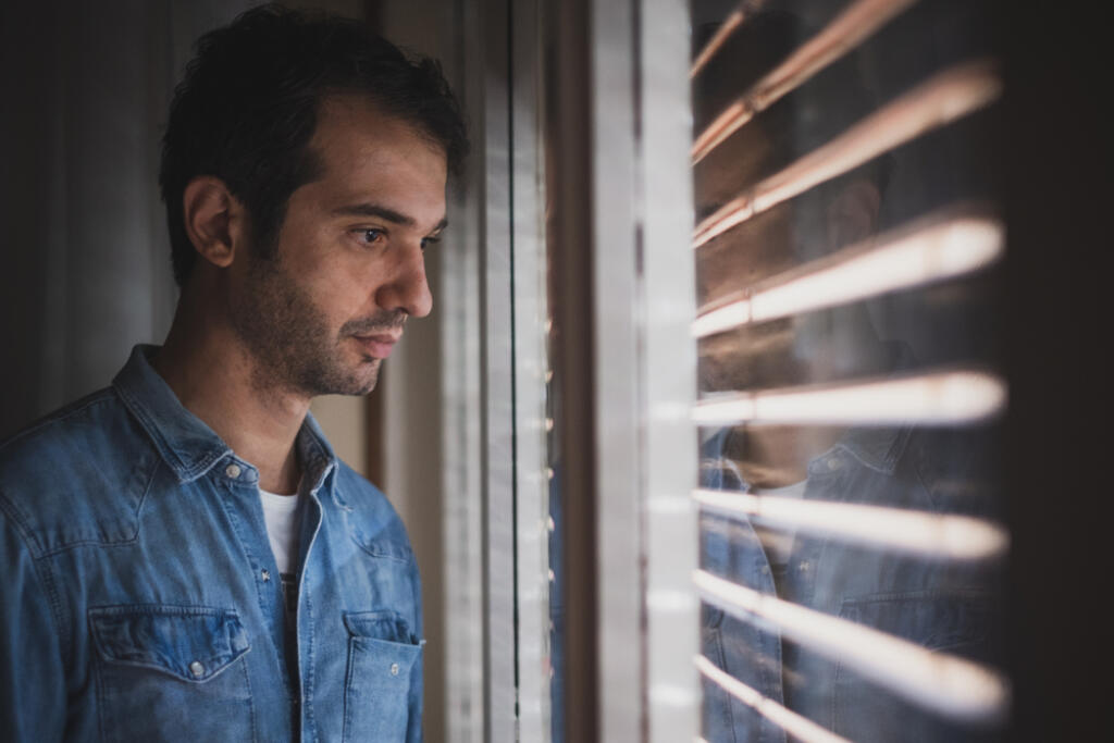 Portrait,Of,Desperate,Man,Looking,Out,The,Window