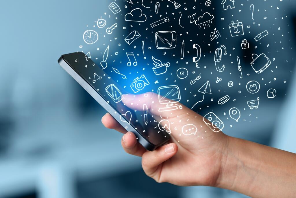 Hand,Holding,Smartphone,With,Hand,Drawn,Media,Icons,And,Symbols