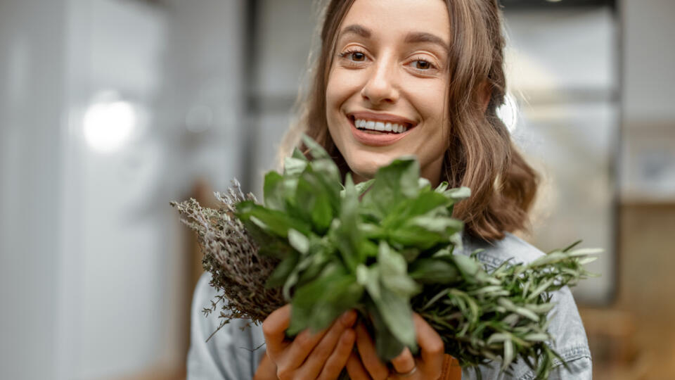 Portrait,Of,Cheerful,Woman,In,Apron,With,Fresh,Spicy,Herbs