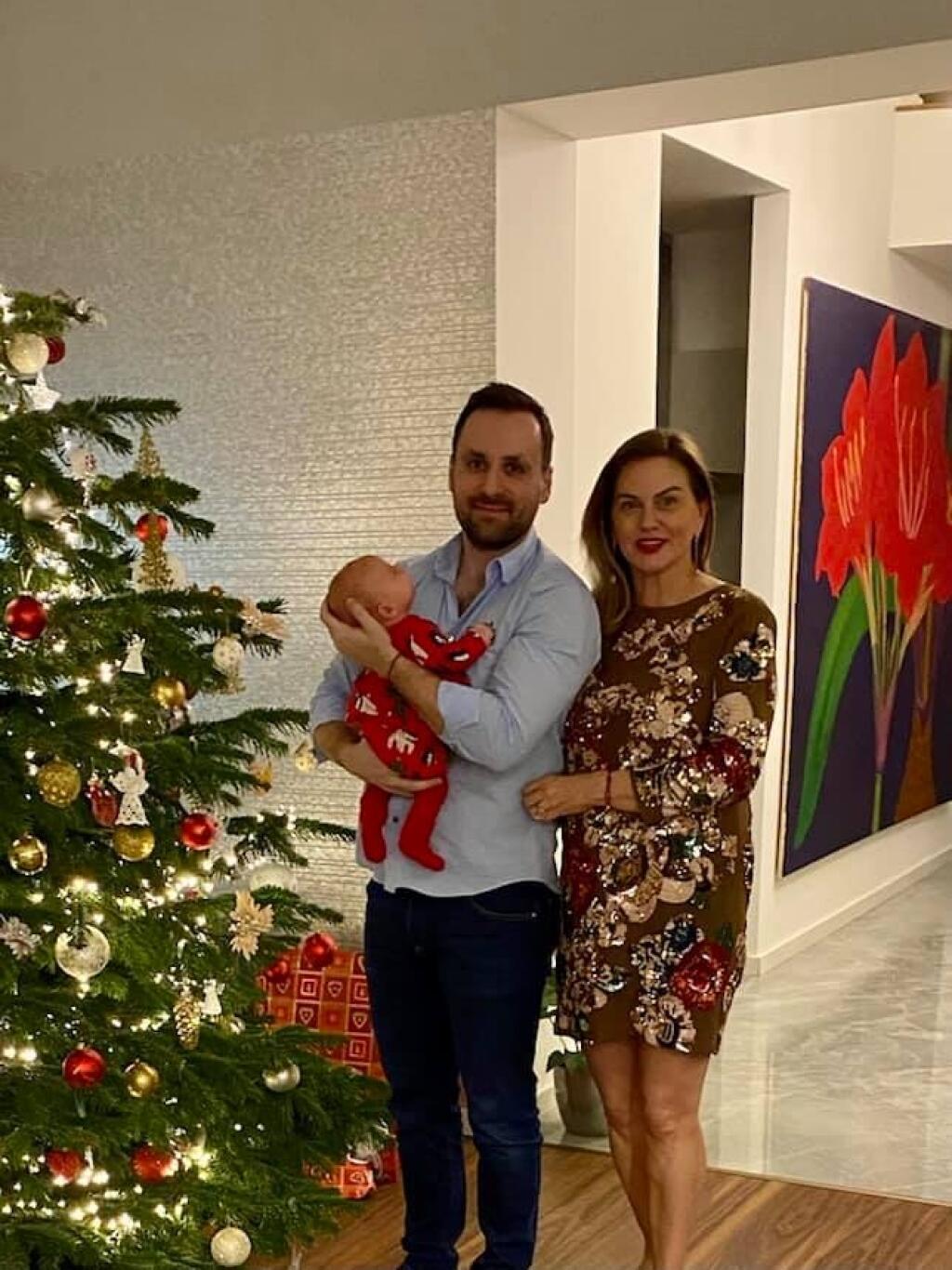 Monika Beňová pri vianočnom stromčeku s malou dcérkou Leou a partnerom Ľubom.