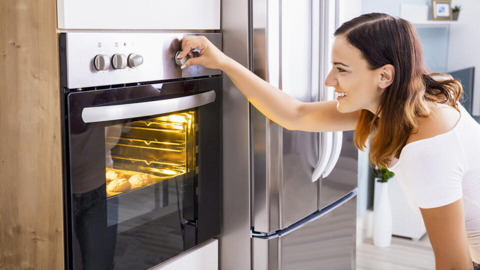 Woman,Baking,In,Oven