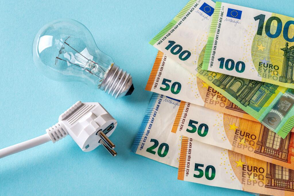 Electric,Plug,,Light,Bulb,And,Euro,Money,Banknotes,Over,Blue