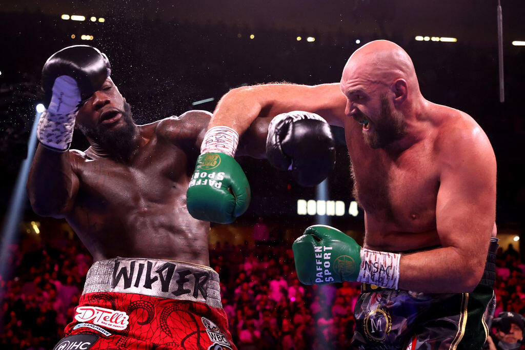 LAS VEGAS, NEVADA - OCTOBER 09: Tyson Fury (R) punches Deontay Wilder during their WBC heavyweight title fight at T-Mobile Arena on October 09, 2021 in Las Vegas, Nevada. (Photo by Al Bello/Getty Images)