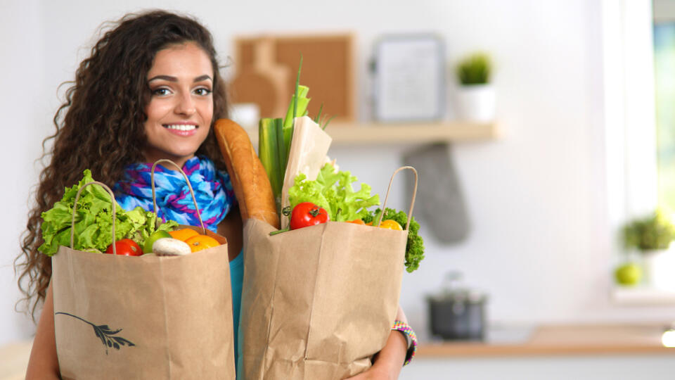 Young,Woman,Holding,Grocery,Shopping,Bag,With,Vegetables,.standing,In