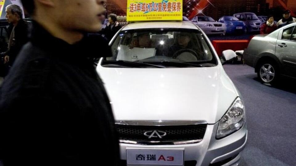 A visitor walks past the Chery Automobile, one of the China biggest automakers on display at an Auto Trade Expo held in Beijing, China, Thursday, Dec. 11, 2008. China is rolling out new measures to reverse a worsening economic slump with interest-free loans to companies and possible steps to boost plunging auto sales and aid steelmakers, the industry minister said Friday. (AP Photo/Andy Wong)