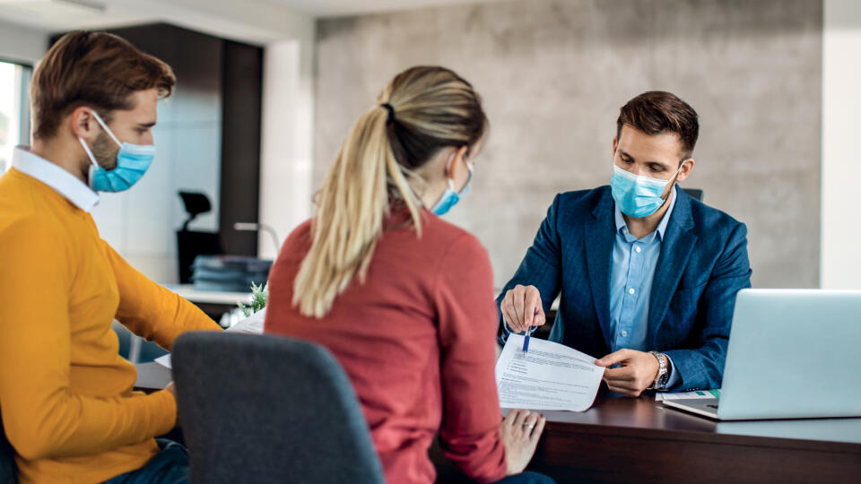 Financial,Advisor,And,A,Couple,Going,Through,Paperwork,While,Having