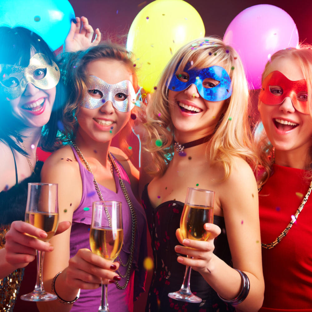Dance happy young girls under masks on the party