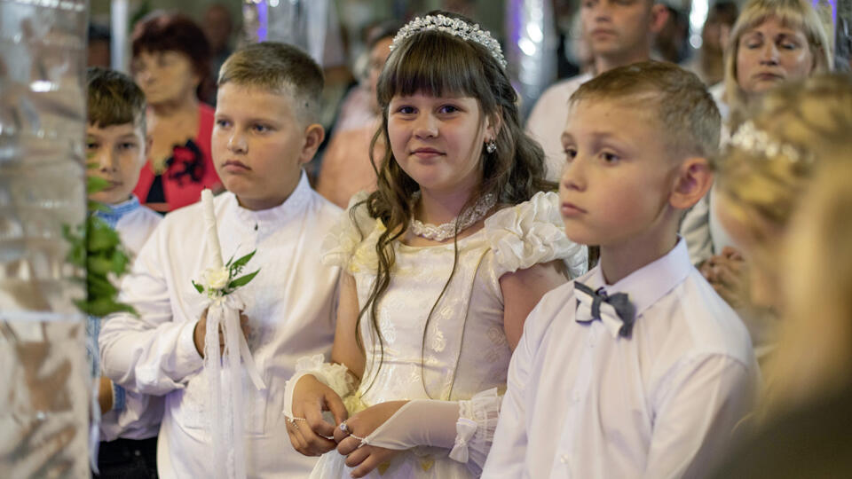 LVIV, UKRAINE - July 4, 2021: The ceremony of a First Communion in the Church of St. Peter the Great of Ukrainian Greek Catholic Church.