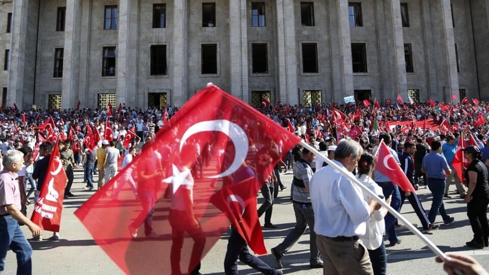 Turkish citizens wave their national flags as they protest against the military coup outside Turkey's parliament near the Turkish military headquarters in Ankara, Turkey, Saturday, July 16, 2016. Forces loyal to Turkey's President Recep Tayyip Erdogan quashed a coup attempt in a night of explosions, air battles and gunfire that left dozens dead Saturday. (AP Photo/Hussein Malla)