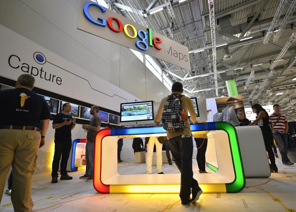 Visitors are testing Google maps products during the photo fair Photokina in Cologne, Germany, Thursday, Sept. 18, 2014. One of the largest fairs for imaging is open until Sept. 21, 2014. (AP Photo/Martin Meissner)
