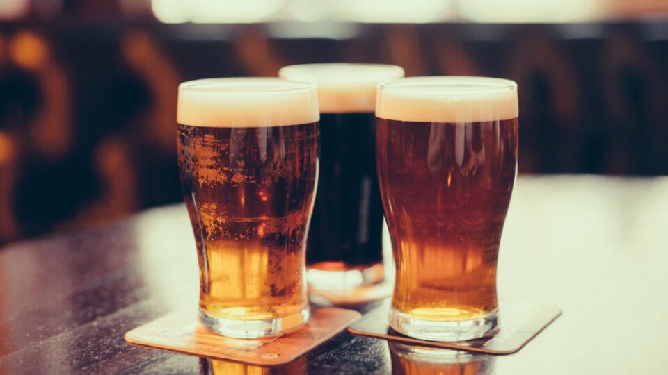 Glasses,Of,Light,And,Dark,Beer,On,A,Pub,Background.