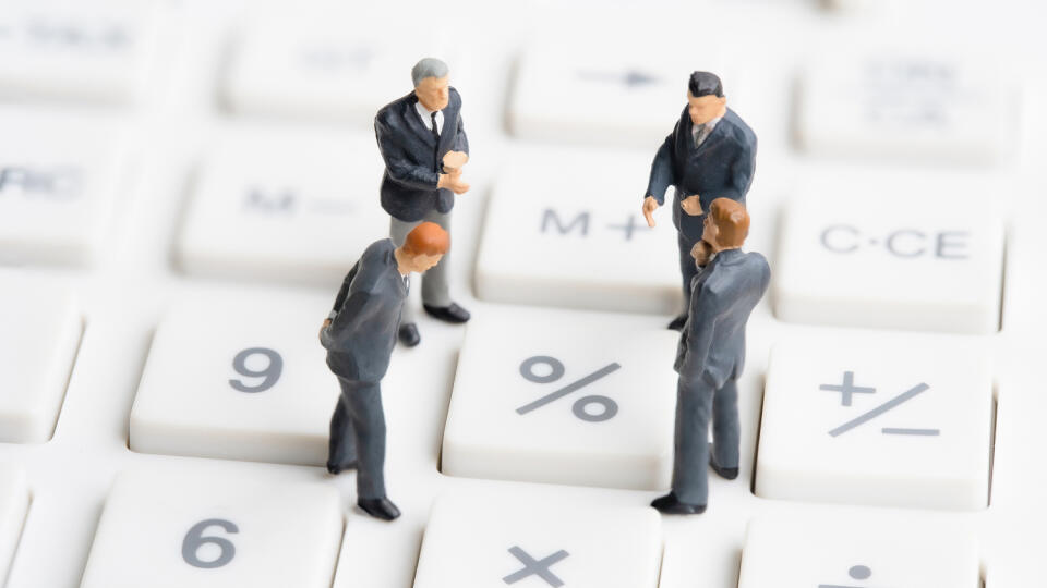 Business,Mans,Standing,On,Calculator.,Interest,Rate,Financial,And,Mortgage