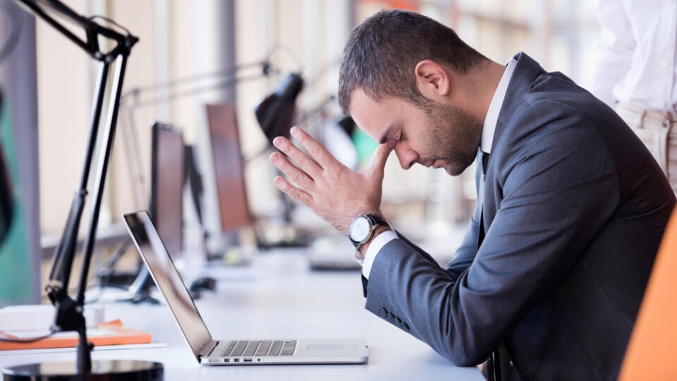 Frustrated,Young,Business,Man,Working,On,Laptop,Computer,At,Office