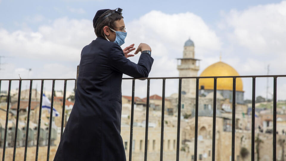 JB 30 Jeruzalem - Ultra-ortodoxný Žid s ochranným rúškom na tvári počas vládneho nariadenia zákazu vychádzania stojí pri modlitbe v Starom Jeruzaleme 8. apríla 2020 s výhľadom na Západný múr. Židovskí veriaci po celom svete oslávia sviatoch pesach, ktorý pripomína oslobodenie Židov z egyptského otroctva. FOTO TASR/AP
In this Wednesday, April 8, 2020 photo, an ultra-Orthodox Jewish man wears a face masks and keep social distancing, following the government's measures to help stop the spread of