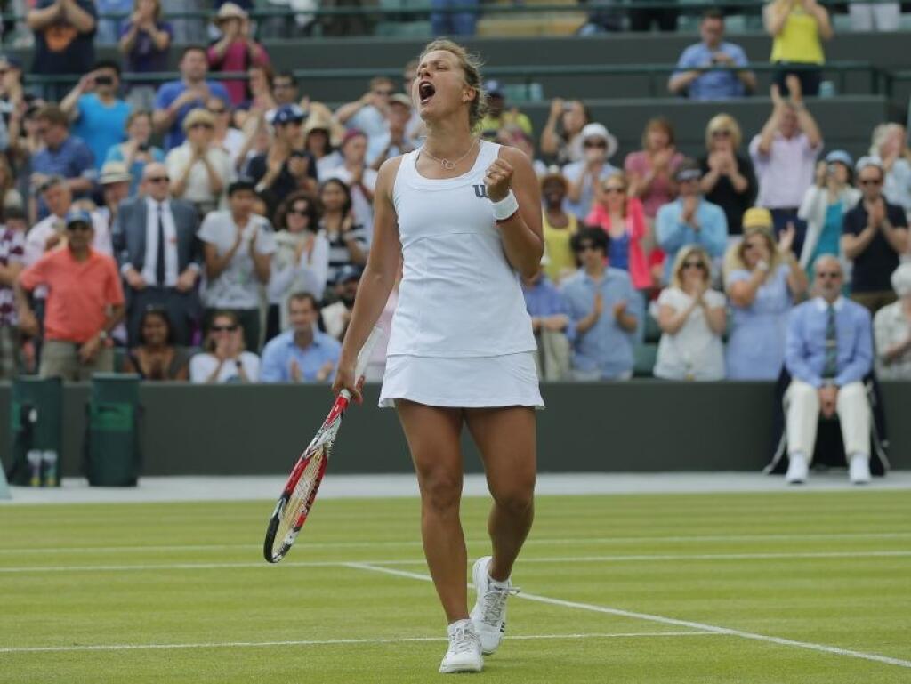 Barbora Zahlavova Strycova of the Czech Republic celebrates winning against Li Na of China in their women's singles match at the All England Lawn Tennis Championships in Wimbledon, London, Friday June 27, 2014. (AP Photo/Pavel Golovkin)