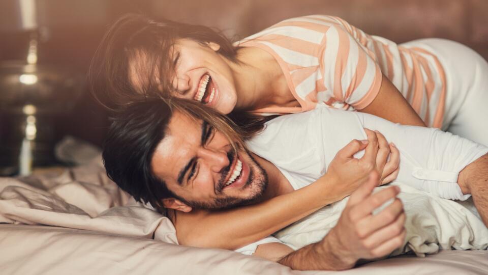 Happy young couple in bed