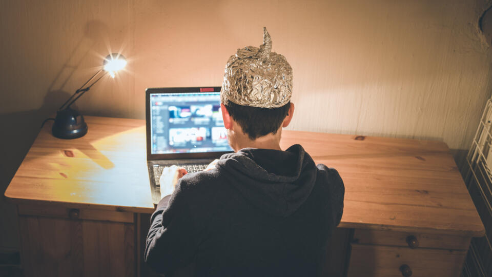 Young,Man,With,Aluminum,Cap,Is,Sitting,In,The,Dark