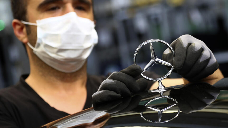 WA 2 Sindelfingen - Zamestnanec s ochranným rúškom sa dotýka znaku Mercedes na automobile Mercedes-Benz triedy S v závode v nemeckom meste Sindelfingen vo štvrtok 30. apríla 2020. Vlastníkom luxusnej značky automobilov Mercedes-Benz je nemecká automobilka Daimler. Tá vykázala za 1. štvrťrok 2020 oveľa nižší zisk ako vlani, keďže aj ju tvrdo zasiahla pandémia nového koronavírusu. FOTO TASR/AP
An employee wearing a face mask to protect against the spread of the new coronavirus attaches a Mercede