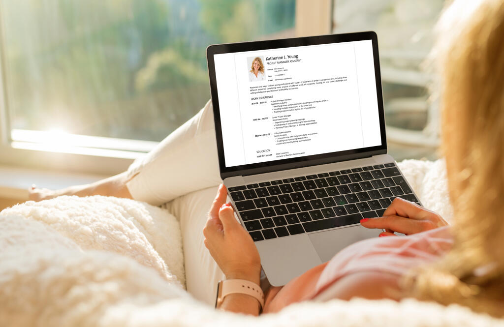 Woman,Creating,Her,Cv,On,Computer,At,Home
