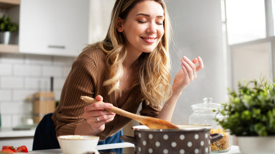 Attractive,Woman,Cooking,In,Modern,Kitchen.,Beautiful,Woman,Cooking,Delicious