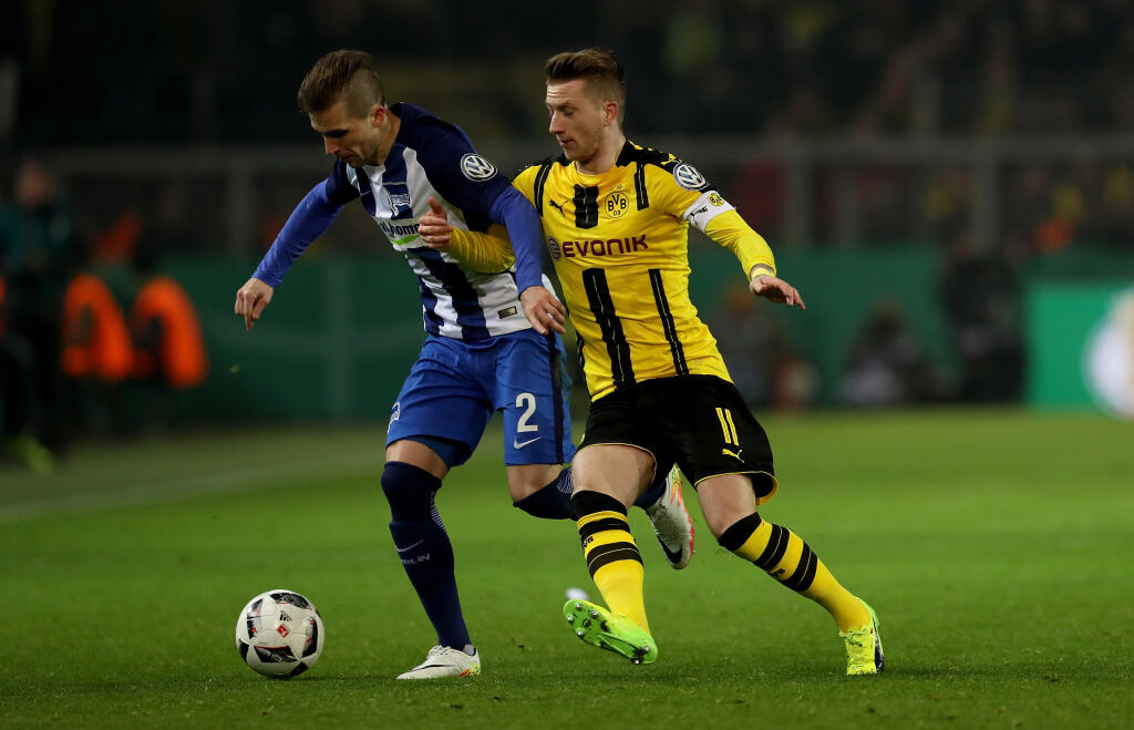 DORTMUND, GERMANY - FEBRUARY 08: Marco Reus (R) of Dortmund and Peter Pekarik of Berlin battle for the ball during the DFB Cup Round of 16 match between Borussia Dortmund and Hertha BSC at Signal Iduna Park on February 8, 2017 in Dortmund, Germany. (Photo by Maja Hitij/Bongarts/Getty Images )