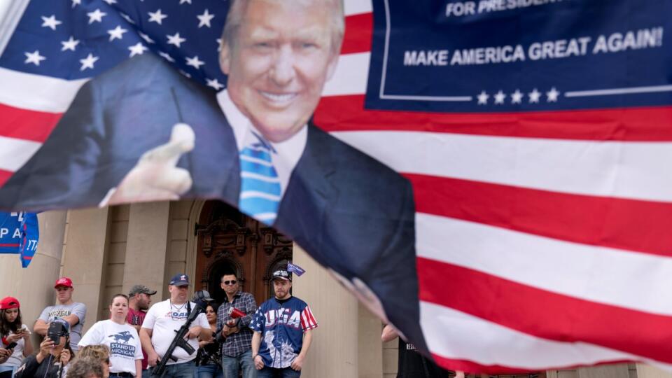 Trump supporters gather on the steps of the State Capitol to protest the presidential election results in Lansing, Mich., Sunday, Nov. 8, 2020