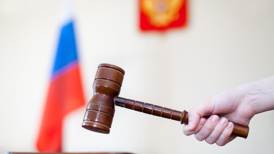 Russian,Justice.,Wooden,Gavel,In,Female,Hand,And,Russian,Flag