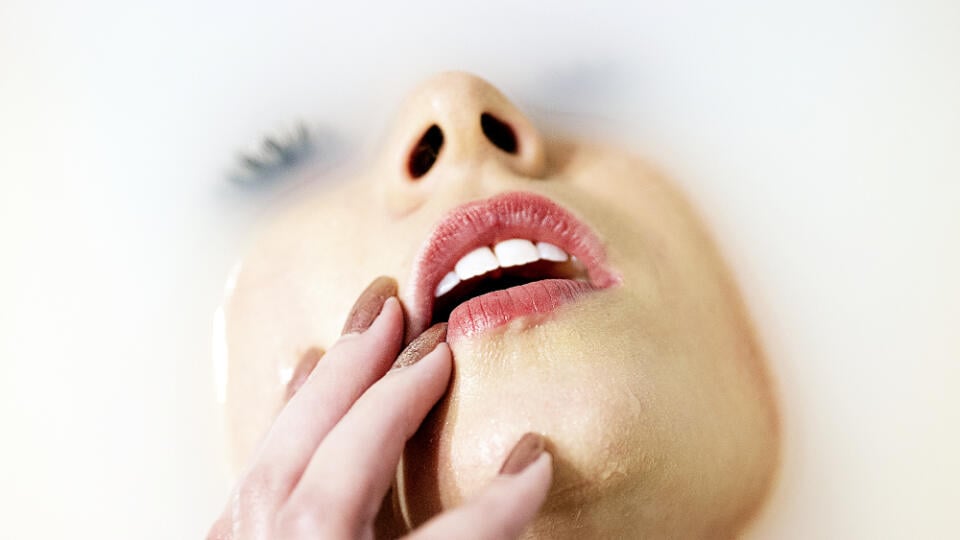 Close-up of young woman with eyes closed in bathtub