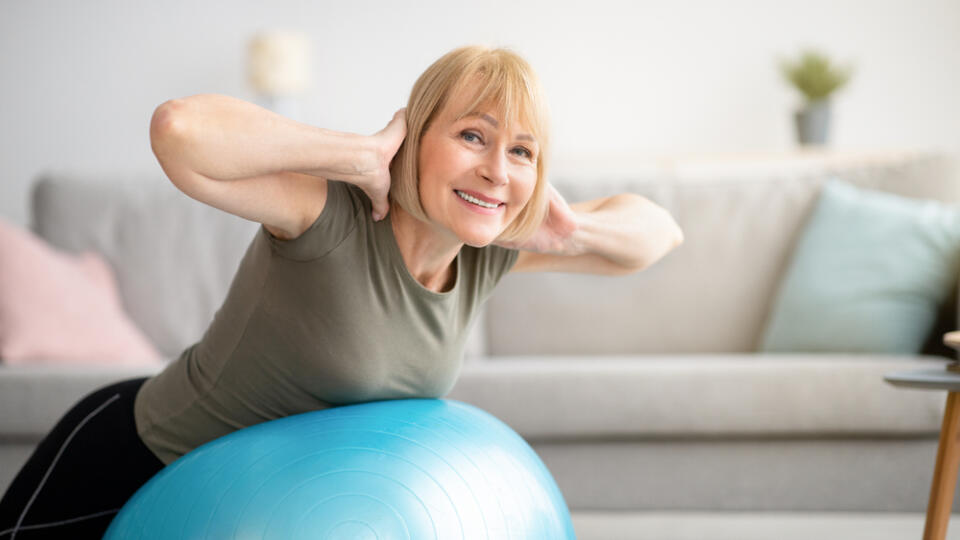 Smiling,Senior,Woman,Doing,Exercises,With,Fitness,Ball,At,Home,