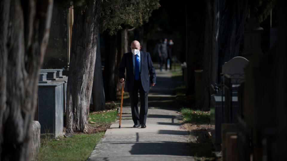 An elderly man walking through the lonely streets of the