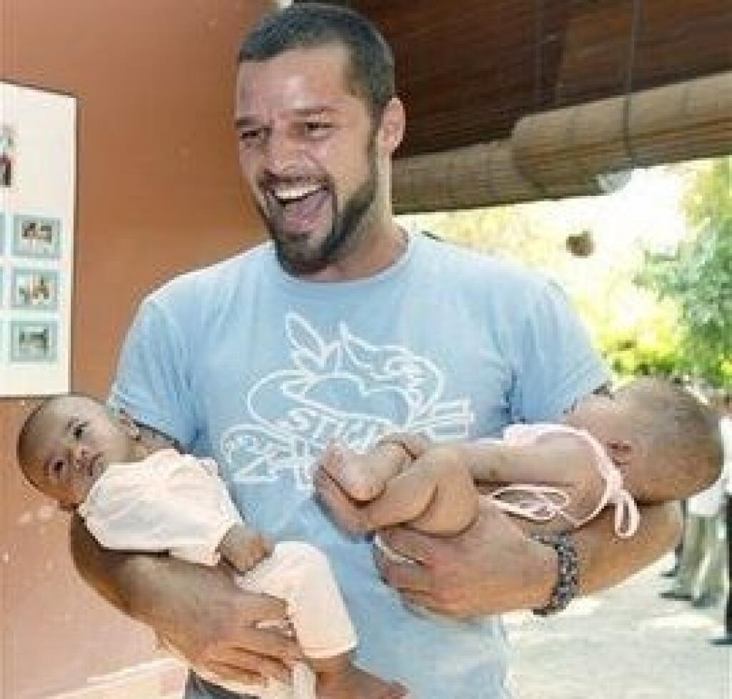 Puerto Rican singer Ricky Martin holds babies during a visit to a shelter for victims of sexual exploitation in Siem Reap northwestern province of Cambodia, Saturday, March 29, 2008. Martin has taken his fight against child trafficking to Cambodia. Martin, who arrived in the country Wednesday, met with Interior Minister Sar Kheng and visited various projects run by non-governmental organizations fighting child trafficking and sexual exploitation. (AP Photo/Heng Sinith)