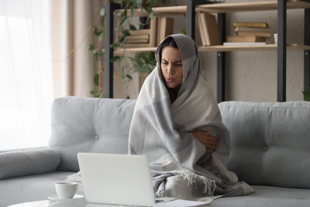 Sick,Ill,Young,Woman,Feel,Cold,Covered,With,Blanket,Sit