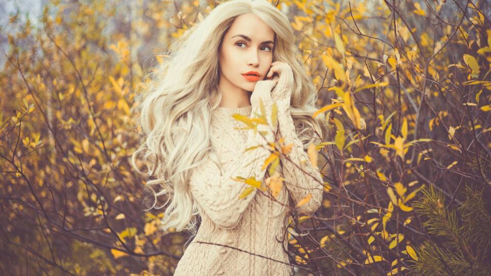 Beautiful lady surrounded autumn leaves