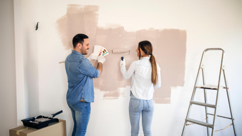 Couple,Renovating,Their,Apartment,While,Man,Holding,Color,Palette,And