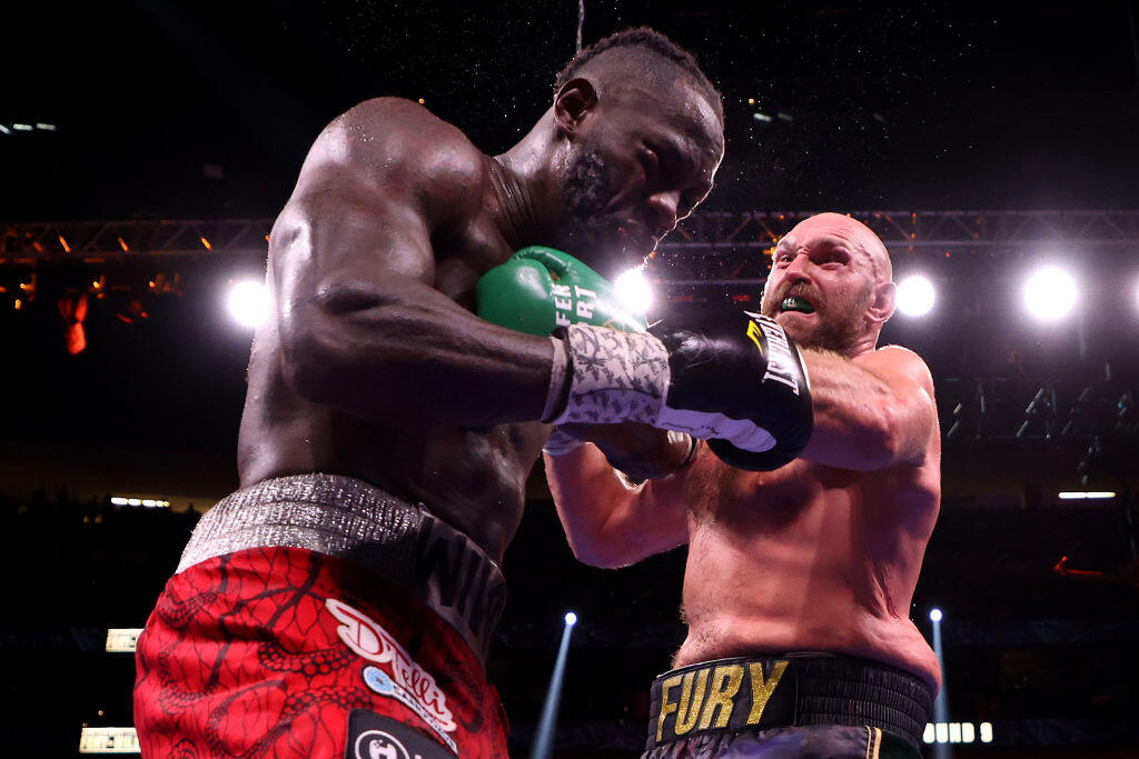 LAS VEGAS, NEVADA - OCTOBER 09: Tyson Fury (R) punches Deontay Wilder during their WBC heavyweight title fight at T-Mobile Arena on October 09, 2021 in Las Vegas, Nevada. (Photo by Al Bello/Getty Images)