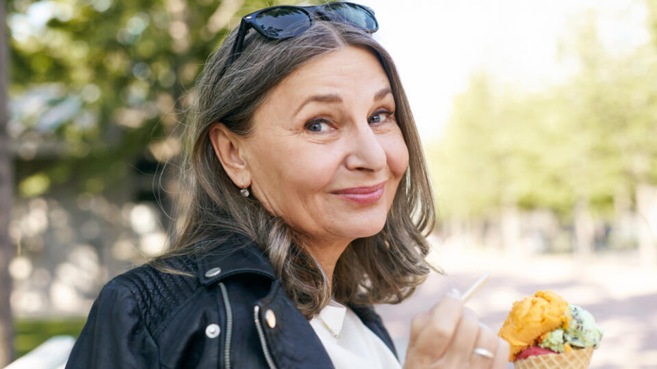 Stylish,Charming,Middle,Aged,Female,In,Black,Leather,Jacket,Holding