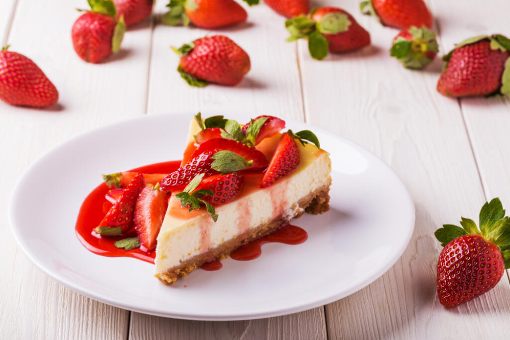 Delicious,Homemade,Cheesecake,With,Strawberries,On,White,Wooden,Table.