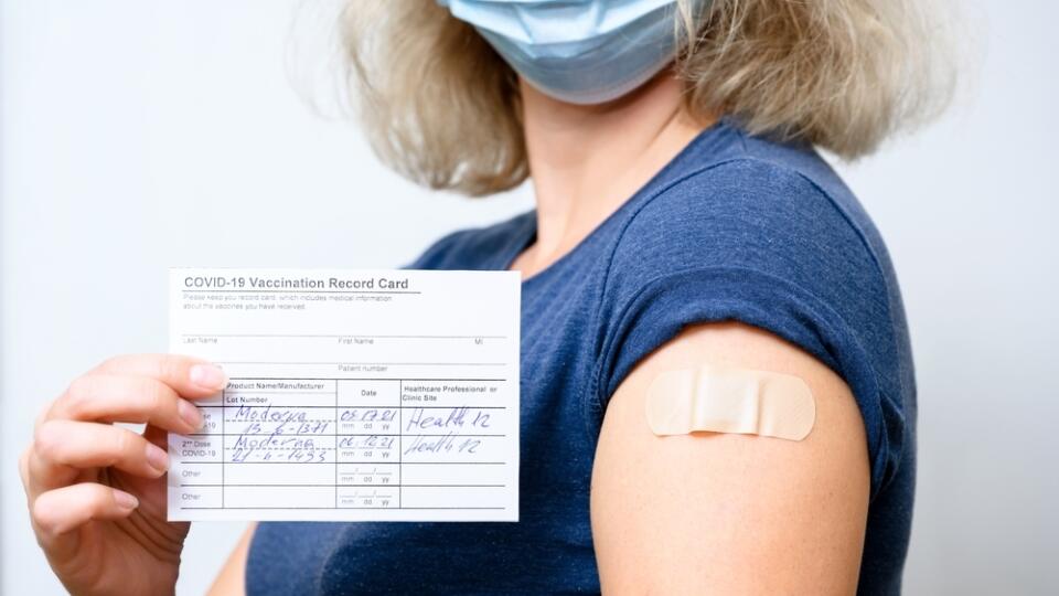 Vaccinated,Young,Woman,In,Mask,Showing,Covid-19,Vaccination,Record,Card,