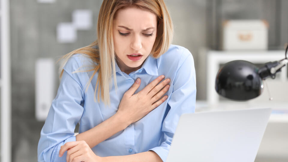 Young,Woman,Suffering,From,Chest,Pain,In,Office