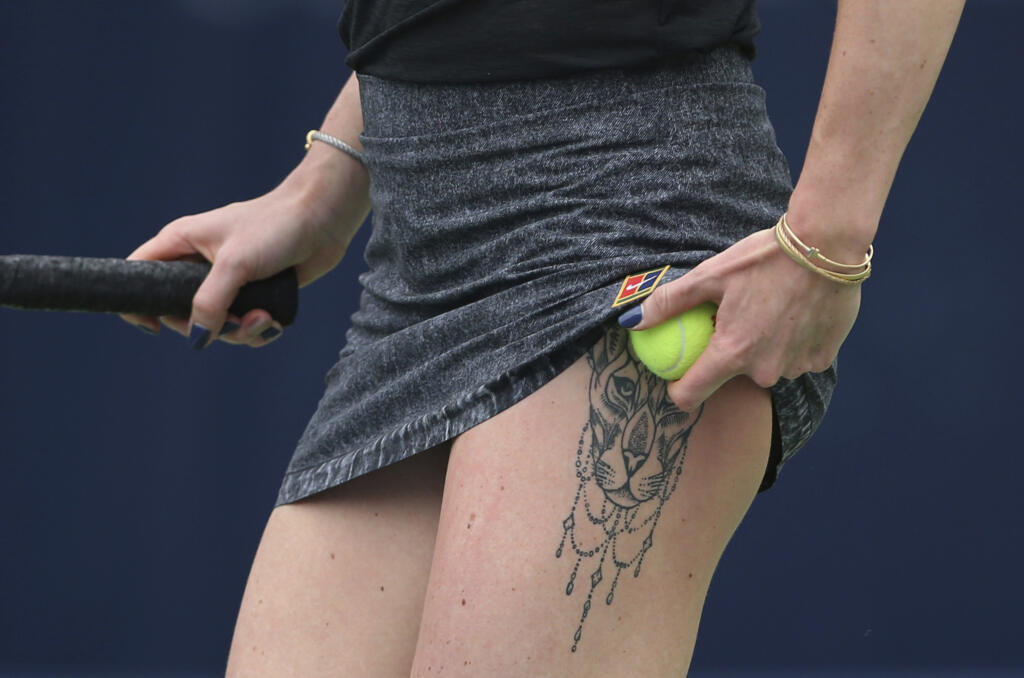Ukraine's Elina Svitolina tattoo is shown as she prepares to serve against Ons Jabeur of Tunisia during a match of the Dubai Duty Free Tennis Championship in Dubai, United Arab Emirates, Tuesday, Feb. 19, 2019. (AP Photo/Kamran Jebreili)