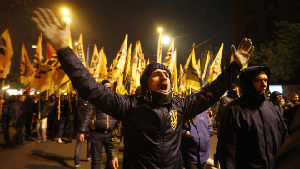 Volunteers of the Azov Civil Corps shout slogans during a rally marking Fatherland Defender Day in Kiev, Ukraine, Friday, Oct. 14, 2016. (AP Photo/Sergei Chuzavkov)