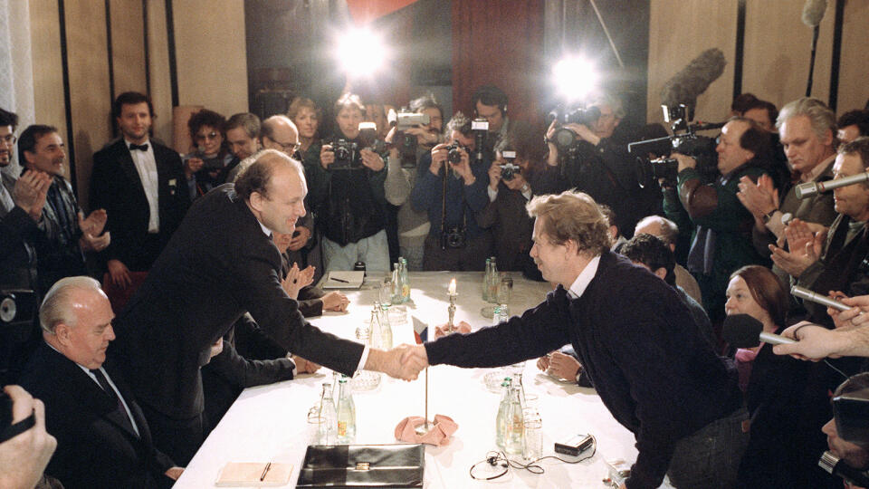 Vaclav Havel (R), a dissident playwright and leading member of the Czechoslovak opposition Civic Forum (Obcanske Forum), who drafted large parts of Charter 77, the declaration which helped attract international attention to the civil rights abuses in Czechoslovakia, shakes hands 26 November 1989 in Prague with future new Prime Minister Marian Calfa, from Slovak dissident movement the "Public Against Violence" while current communist Premier Ladislav Adamec (L) watches. A new government was forme