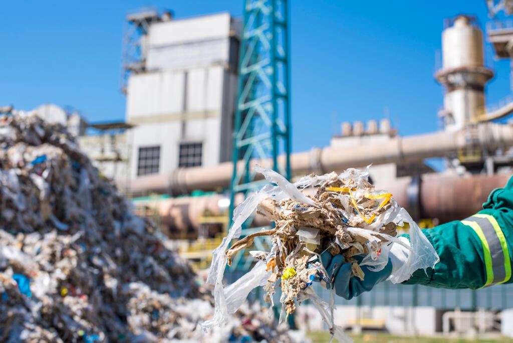 Man,Holding,Shredded,Municipal,Waste,In,Front,Of,Rotary,Cement