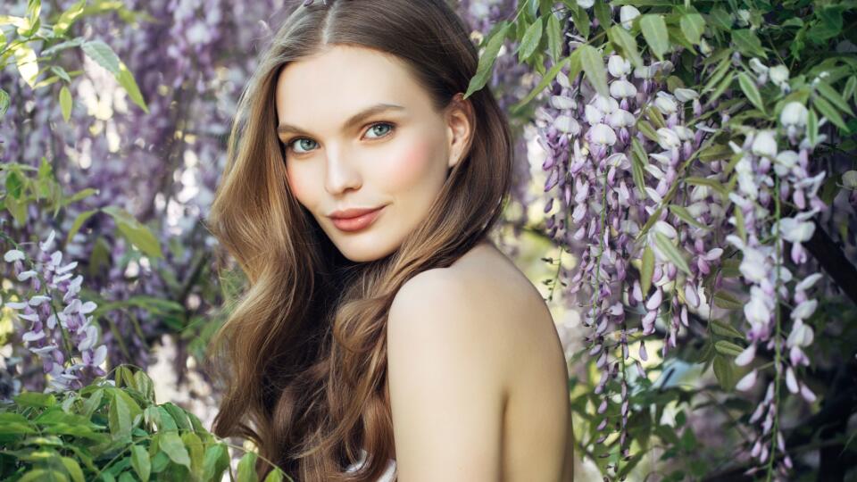 Beautiful girl on the background of spring bush