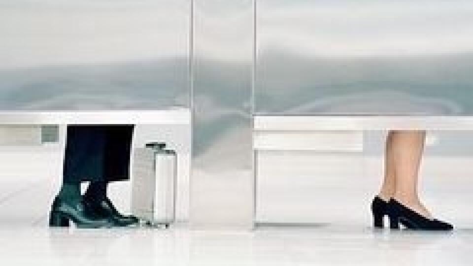 Women in bathroom stalls, low section
