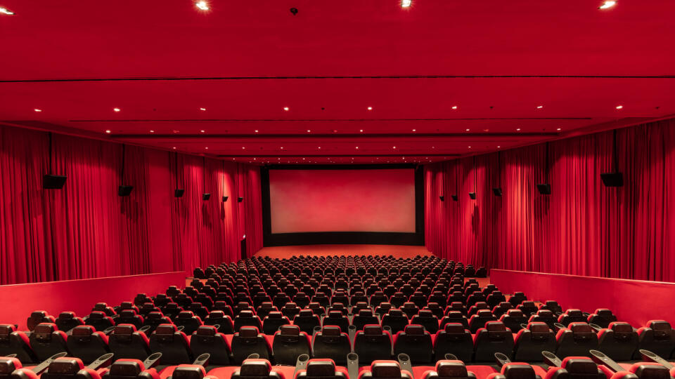 Empty red cinema hall seats, chairs. Perspective view