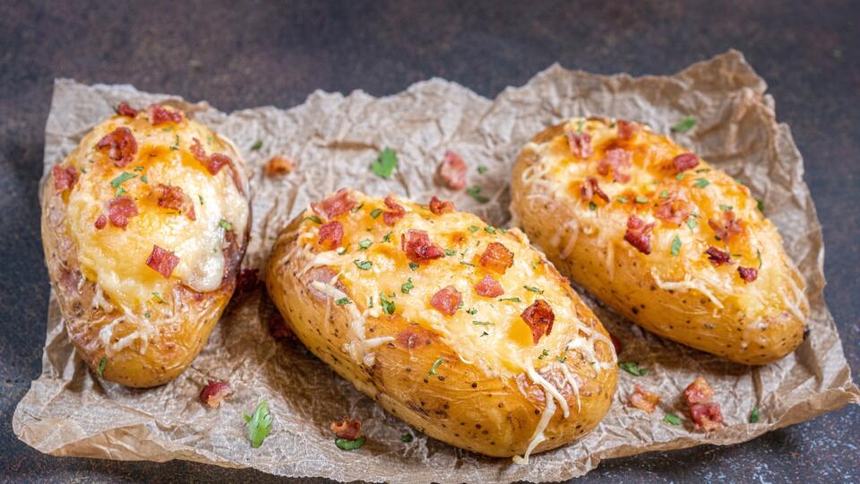 Baked loaded potato with bacon, cheese and onion