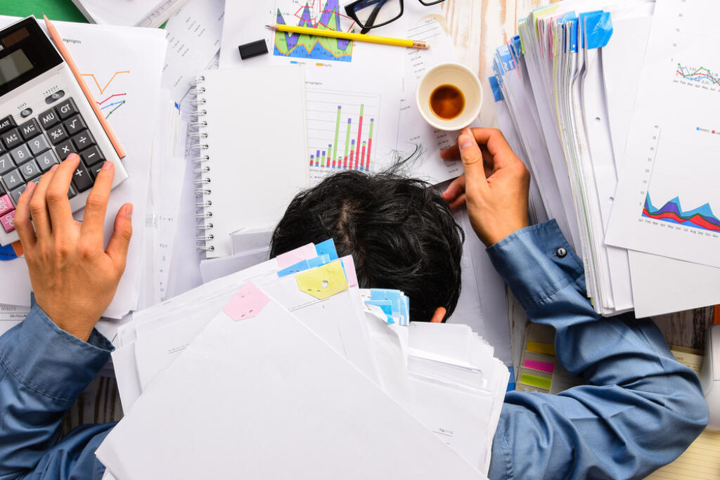 Businessman,Heavy,Workload,Sleep,At,Office,Desk,With,Finance,Sheet