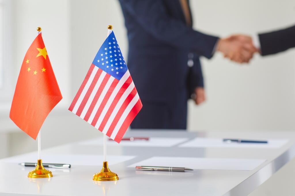 Flags,Of,China,And,America,Against,Background,Of,Handshakes,Of